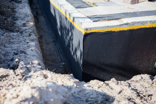Professional Basement Waterproofing technician working in Elwood, NY